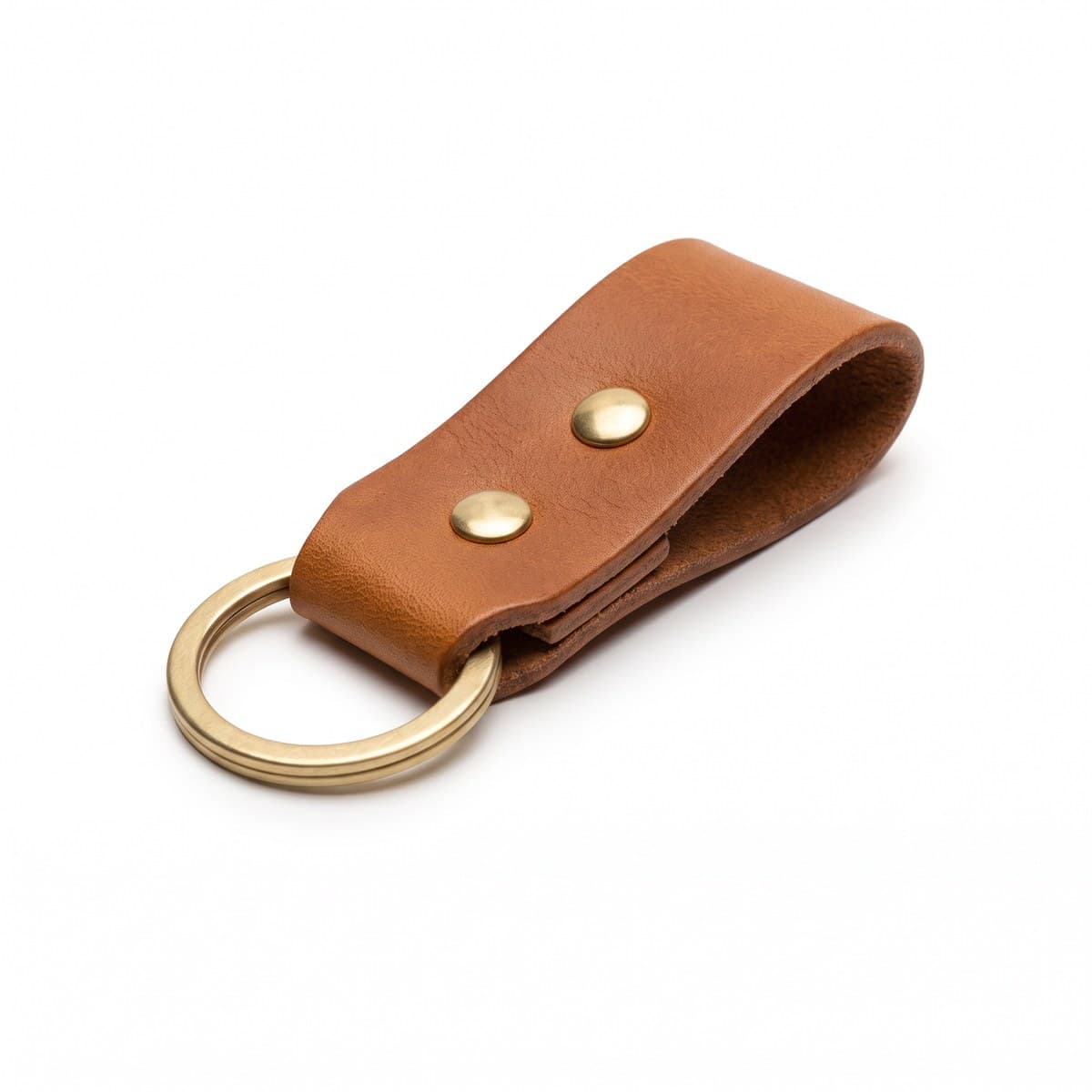A tan full-grain leather key fob with a riveted brass split ring